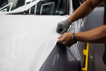 車体にシートを貼り込む手元